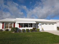 Charming single-story home with a well-manicured lawn, white exterior, and a two-car garage at 9208 37Th N St, Pinellas Park, FL 33782