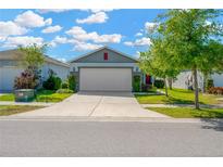 Charming one-story home with a well-manicured lawn and a two-car garage, creating a welcoming curb appeal at 11221 Gold Compass St, Gibsonton, FL 33534