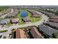 Aerial view of property showcasing lush landscaping, and serene water view within a well-planned community at 15635 Sacile Ln, Bradenton, FL 34211