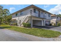 Two-story condo building featuring private balconies, covered parking, and well-manicured lawns at 1830 Bough Ave # 2, Clearwater, FL 33760