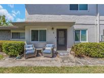 Close up of a condo entrance with an inviting seating area on the front patio at 1830 Bough Ave # 2, Clearwater, FL 33760