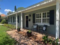 Charming home featuring a cozy front porch with seating and decorative accents at 3316 S Shamrock Rd, Tampa, FL 33629
