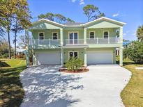 Beautiful two story exterior with two garages, balconies, and a well manicured yard at 4559 Mitcher Rd, New Port Richey, FL 34652