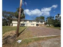 An exterior view of the home shows the structure and surrounding grounds at 4628 Cypress S Way, St Petersburg, FL 33705
