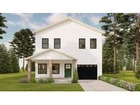 Charming two-story home featuring a black garage door, green front door, and a cozy covered porch at 4985 16Th N Ave, St Petersburg, FL 33710