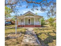 Charming home with a quaint front porch, landscaped yard, and walkway leading to the entrance at 5912 N Lynn Ave, Tampa, FL 33604