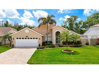 Charming single-story home with manicured lawn, lush landscaping, and inviting curb appeal at 6716 Frontier Ln, Tampa, FL 33625