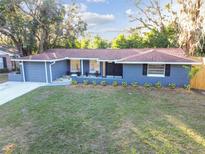 Charming single-story home featuring a well-manicured lawn, mature trees and a freshly painted exterior at 7804 N Whittier St, Tampa, FL 33617