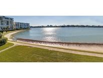 Scenic beachfront view with modern condos, calm waters, and sunny skies at 7984 Sailboat Key S Blvd # 105, South Pasadena, FL 33707