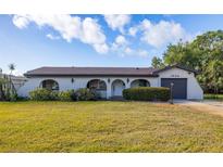 Charming single-story home featuring a stucco exterior, arched entryway, and well-manicured landscaping at 1032 26Th S Ave, St Petersburg, FL 33705