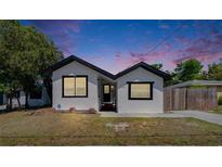 Charming single-story home featuring a freshly painted white exterior, black trim, and a well-maintained front yard at 1138 Howard St, Clearwater, FL 33756