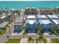 Stunning aerial view of beach condos with turquoise waters and nearby buildings at 16306 1St E St, Redington Beach, FL 33708