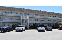 Attractive condo building featuring exterior stairs and ample parking at 2284 Philippine Dr # 41, Clearwater, FL 33763