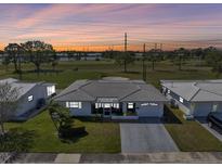 A single Gathering home at sunset on a golf course with mature trees and well-maintained landscaping at 3808 97Th N Ave, Pinellas Park, FL 33782