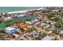 Gorgeous aerial view of waterfront homes and vibrant community near beach, offering serene coastal living and city access at 4151 Belle Vista Dr, St Pete Beach, FL 33706
