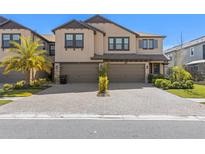 Beautiful two-story home with a two-car garage and a paver driveway and lush landscaping at 4600 Lagona Ln, Wesley Chapel, FL 33543
