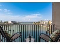 Balcony with two chairs has beautiful water views perfect for relaxing with a drink at 7300 Sun Island S Dr # 202, South Pasadena, FL 33707