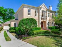 Charming two-story home with landscaped yard, elegant architectural details and a welcoming entrance at 2927 W Bayshore Ct, Tampa, FL 33611
