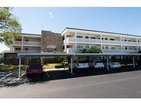 Exterior view of condo building, showing parking spaces and covered parking spots at 4910 Bay Ne St # 308, St Petersburg, FL 33703