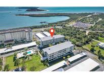 Beautiful coastal condominium complex with lush landscaping and water views from every unit at 5 Island Park Pl # 305, Dunedin, FL 34698