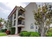 Condo building with beautiful landscaping, brick pavers, and private balconies at 895 S Gulfview Blvd # 309, Clearwater Beach, FL 33767