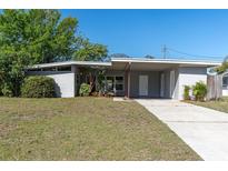 Charming single-story home with a carport, well-maintained lawn, and fresh landscaping at 10426 109Th St, Seminole, FL 33778