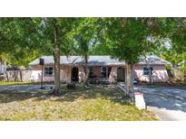 Charming single-story home with mature trees, quaint arched doorways, and a well-kept front yard at 15204 Westminister Ave, Clearwater, FL 33760