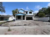 New home being built with concrete blocks and covered with blue moisture barrier under a partly cloudy sky at 1627 48Th N Ave, St Petersburg, FL 33714