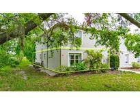 Inviting two-story condo with manicured landscaping and verdant tree coverage at 367 Bobby Jones Rd # 367, Sarasota, FL 34232