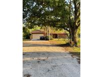 Charming single-story home with a large front yard and attached two-car garage offering a cozy and inviting curb appeal at 7006 41St E Ave, Bradenton, FL 34208