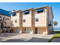 Three-story condo building featuring private garages and direct beach access at 12512 1St W St # 2, Treasure Island, FL 33706