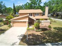 Charming two-story home with a well-manicured lawn and attached two-car garage at 3103 Taragrove Dr, Tampa, FL 33618