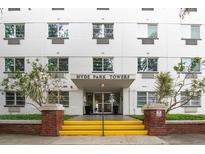Exterior view of Hyde Park Towers, featuring yellow stairs leading to the entrance at 406 W Cedar St # 403, Tampa, FL 33606