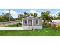 Charming single-story home with a covered front porch, well-maintained lawn, and newly installed driveway at 1423 Venetia St, Nokomis, FL 34275