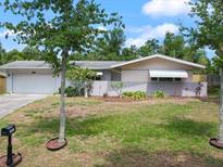 Charming single story home with a well-manicured lawn and beautiful curb appeal at 1531 Picardy Cir, Clearwater, FL 33755