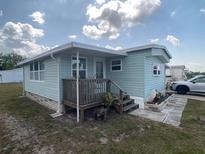 Charming home featuring a cozy porch and landscaped garden area at 1710 7Th Sw St # 24, Ruskin, FL 33570