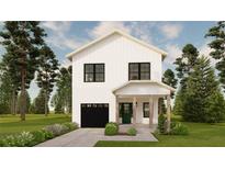 Charming two-story home features a black garage door, green front door, and lush landscaping, creating great curb appeal at 4995 16Th N Ave, St Petersburg, FL 33710