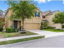Inviting two-story home with a well-manicured lawn and a two-car garage, perfect for Gathering living at 5946 81St N Ave, Pinellas Park, FL 33781