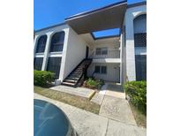 Inviting two-story condo building with well-maintained landscaping and open stairwell at 7701 Starkey Rd # 602, Seminole, FL 33777