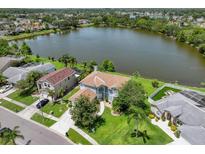 Waterfront home with lush green landscaping, and beautiful lake views at 11519 Glenmont Dr, Tampa, FL 33635
