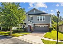Charming two-story home featuring a brick-paved driveway and manicured lawn at 19309 Prairie Tree Pl, Tampa, FL 33647