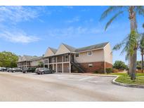 Apartment building with stairs and car park on a beautiful sunny day at 200 Country Club Dr # 308, Largo, FL 33771