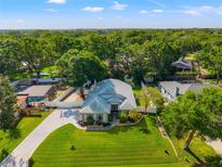Beautiful aerial view of home with mature trees, well manicured lawn, and a charming exterior at 22304 Stillwood Dr, Land O Lakes, FL 34639