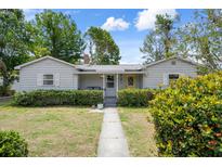 Charming single-story home with a landscaped front yard, cozy porch, and bright yellow door, perfect for curb appeal at 5148 3Rd N Ave, St Petersburg, FL 33710