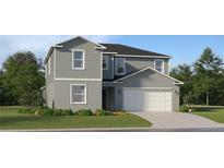 Charming two-story home with a two car garage, lush lawn, and beautiful, neutral toned color scheme at 5689 Yellow Hornbill Ave, Wimauma, FL 33598
