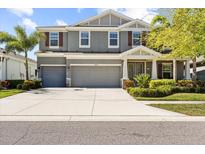 Charming two-story home with a three-car garage, well-manicured lawn, and inviting curb appeal at 5809 Alabaster Stone Ln, Apollo Beach, FL 33572