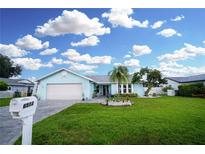 Charming one-story home with a well-manicured front yard and a paved driveway at 6513 14Th W Ave, Bradenton, FL 34209