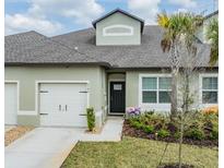 Charming single-Gathering home showcasing a well-maintained lawn and a one-car garage at 6748 Ripple Pond Loop, Zephyrhills, FL 33541