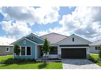 Charming one-story home features a two-car garage, paver driveway, and well-manicured lawn at 18051 Foxtail Loop, Venice, FL 34293