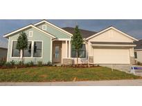Charming single-story home showcasing a two-car garage, manicured lawn, and inviting front entrance at 18051 Foxtail Loop, Venice, FL 34293